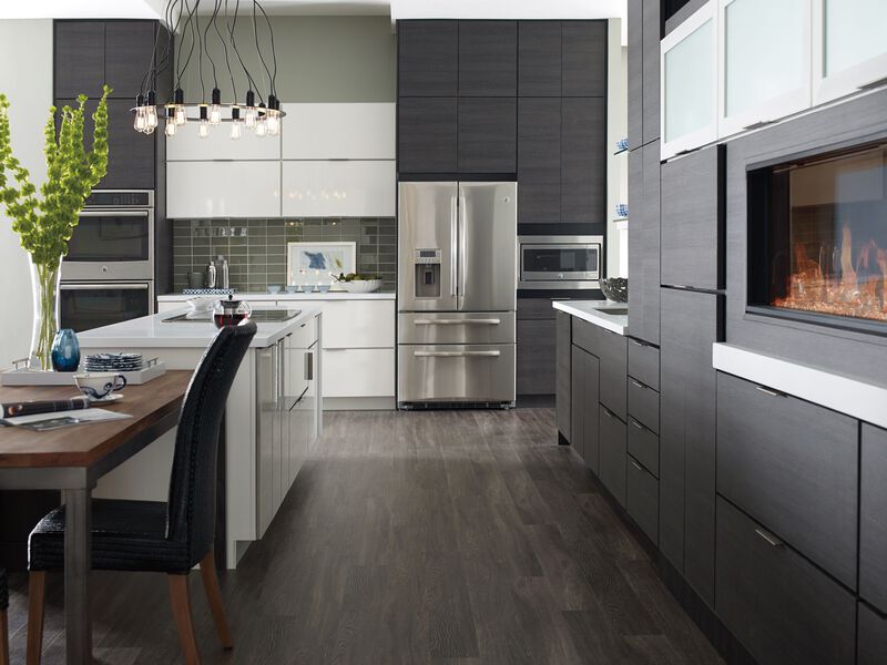 A modern kitchen featuring sleek, high-gloss white thermofoil cabinets 