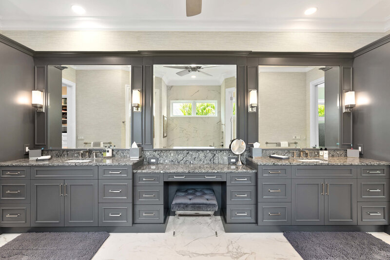 A custom vanity cabinet installed in a luxury bathroom, showcasing intricate design and craftsmanship