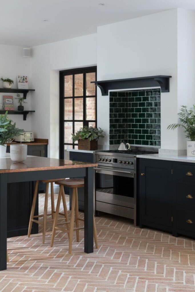 Warm Kitchen Cabinet Colors: Contemporary kitchen featuring soft terracotta cabinets, black fixtures