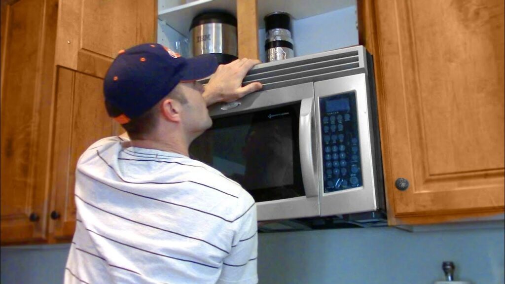 Professional installing a microwave cabinet with precision and care