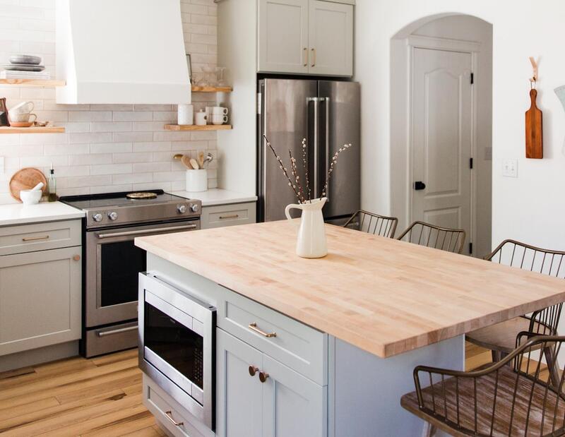 Microwave cabinet integrated into a kitchen island for modern design.