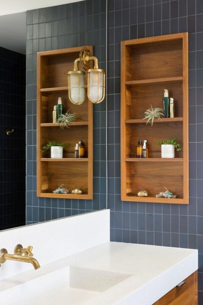 A vanity cabinet with built-in open shelves displaying towels and decor in a contemporary bathroom