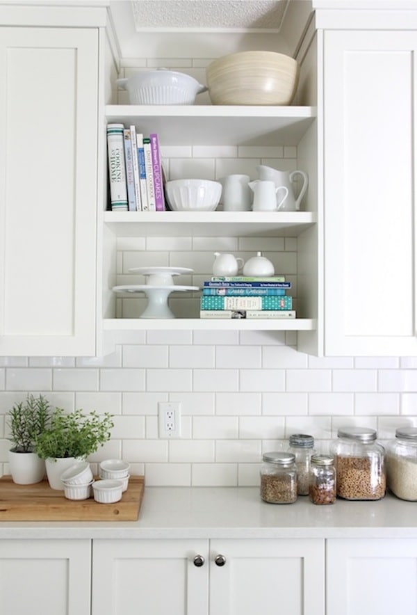 Contemporary kitchen featuring open shelves cabinet with decorative plants and kitchen essentials