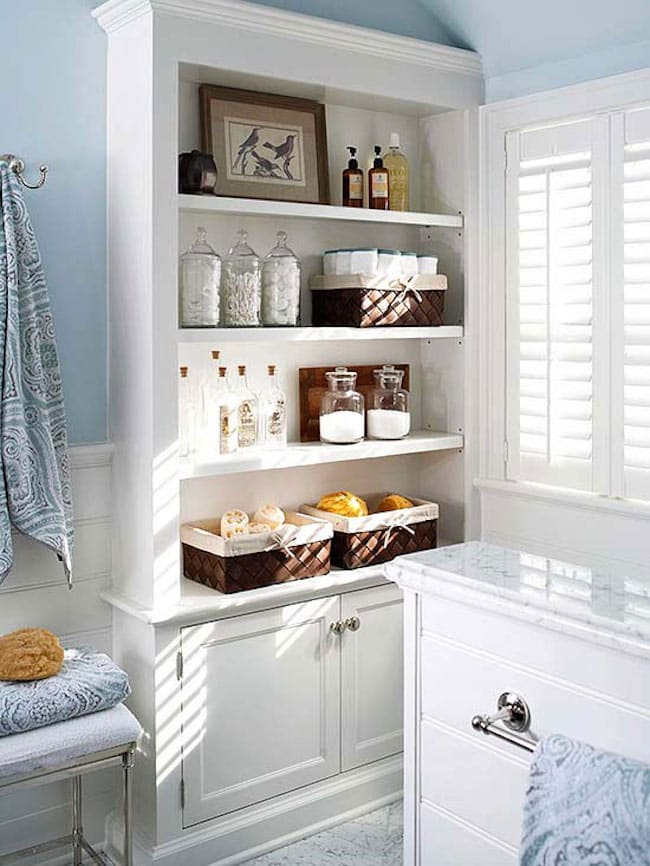 Elegant bathroom showcasing a stylish cabinet with open shelves for storage and decor