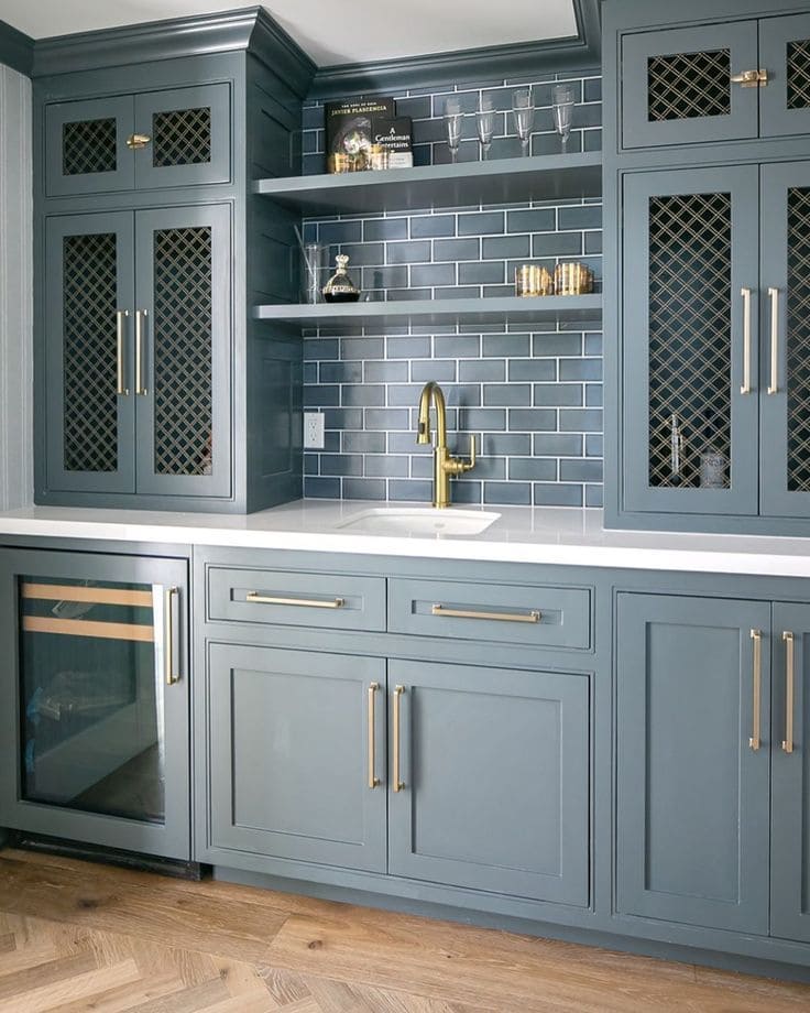 Industrial-style kitchen featuring blue-grey painted cabinets