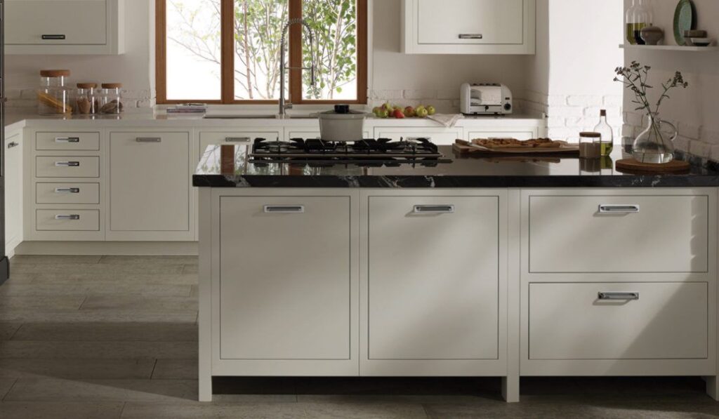 Minimalist kitchen featuring warm white slab door cabinets.