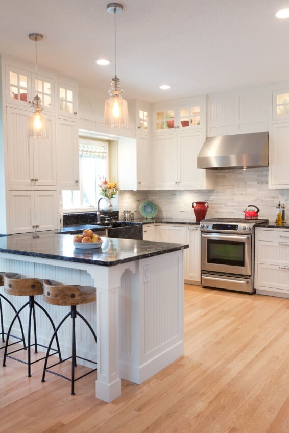 Minimalist kitchen with matte white painted cabinets and light wood floors