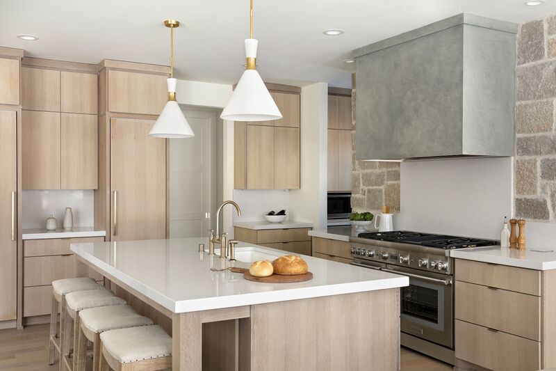 Modern kitchen featuring warm white cabinets, oak flooring