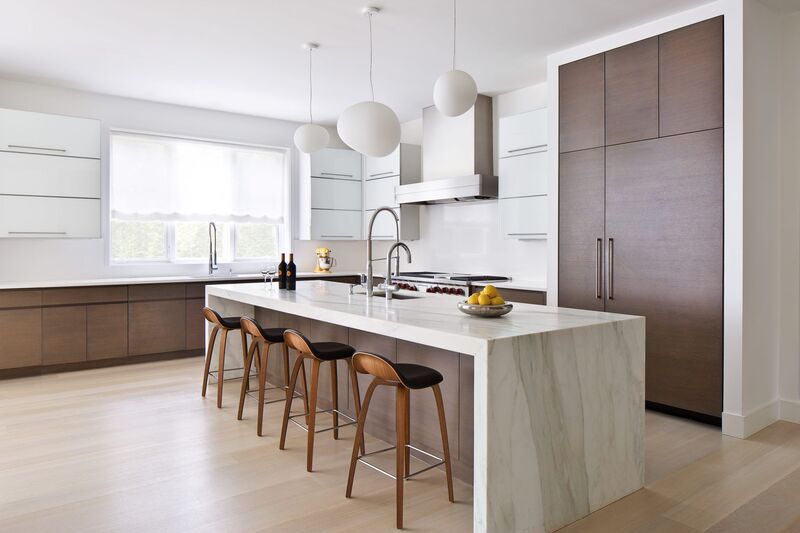 Modern kitchen showcasing a standard kitchen island height with a sleek countertop and bar stools