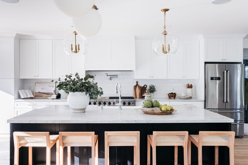 Modern kitchen showcasing white painted cabinets with marble countertops