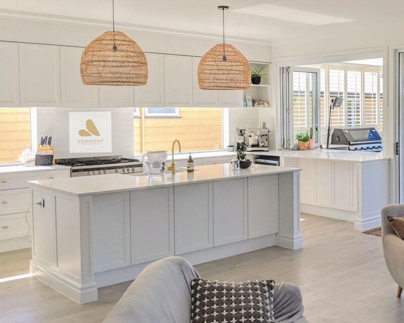 Modern kitchen with a shaker-style kitchen island featuring white cabinetry