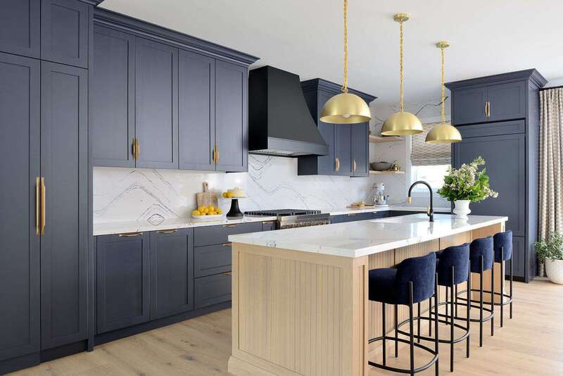 Modern kitchen with glossy navy painted cabinets and gold fixtures for a bold, luxurious look