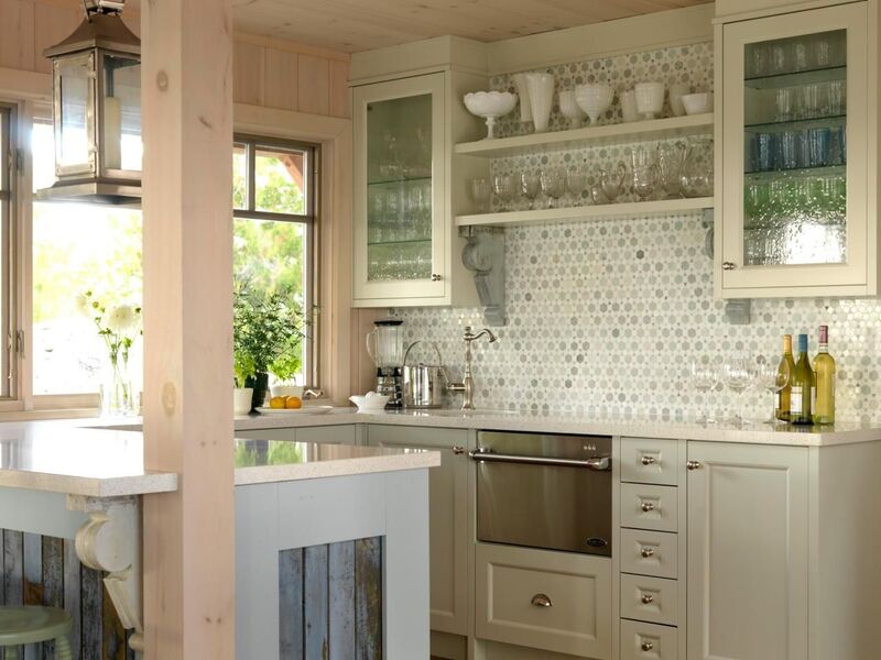 Modern kitchen with open shelves cabinets displaying glassware and plants, creating an airy aesthetic