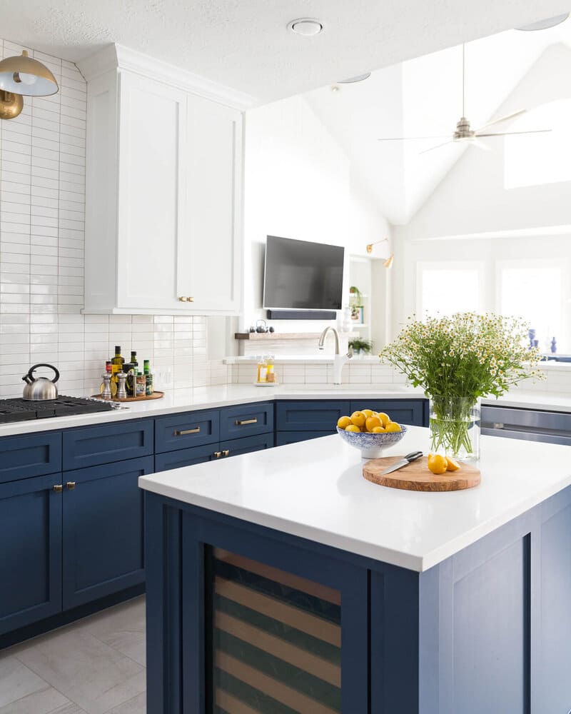 Modern kitchen with white upper cabinets and navy blue lowers