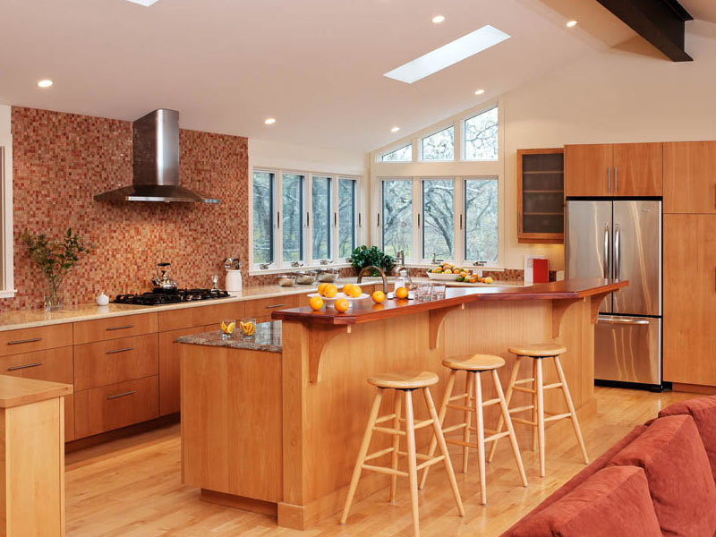 Multi-level kitchen island with distinct areas for food prep, dining, and socializing