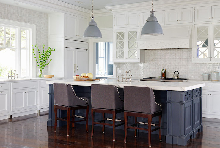 Navy blue shaker style kitchen island with recessed paneling and a white quartz countertop in a transitional kitchen