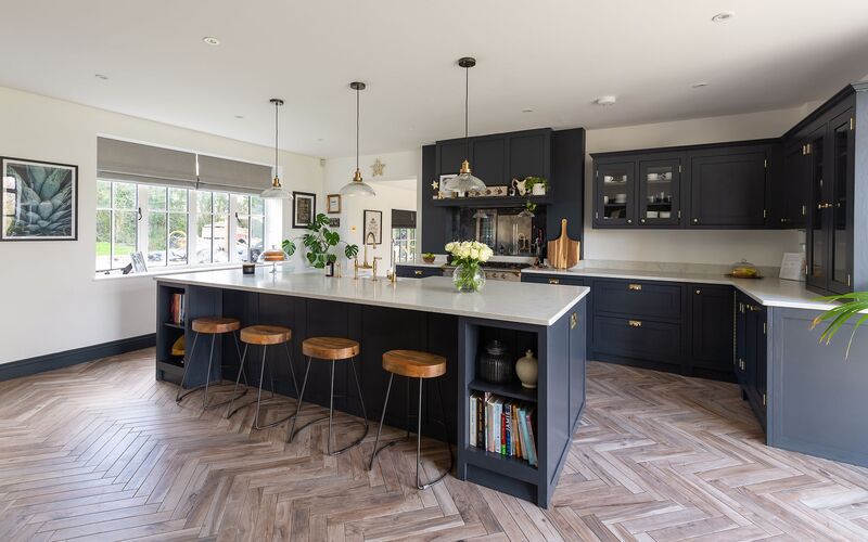 Shaker style kitchen island with a deep navy base and white quartz countertop, showcasing bold contrasts