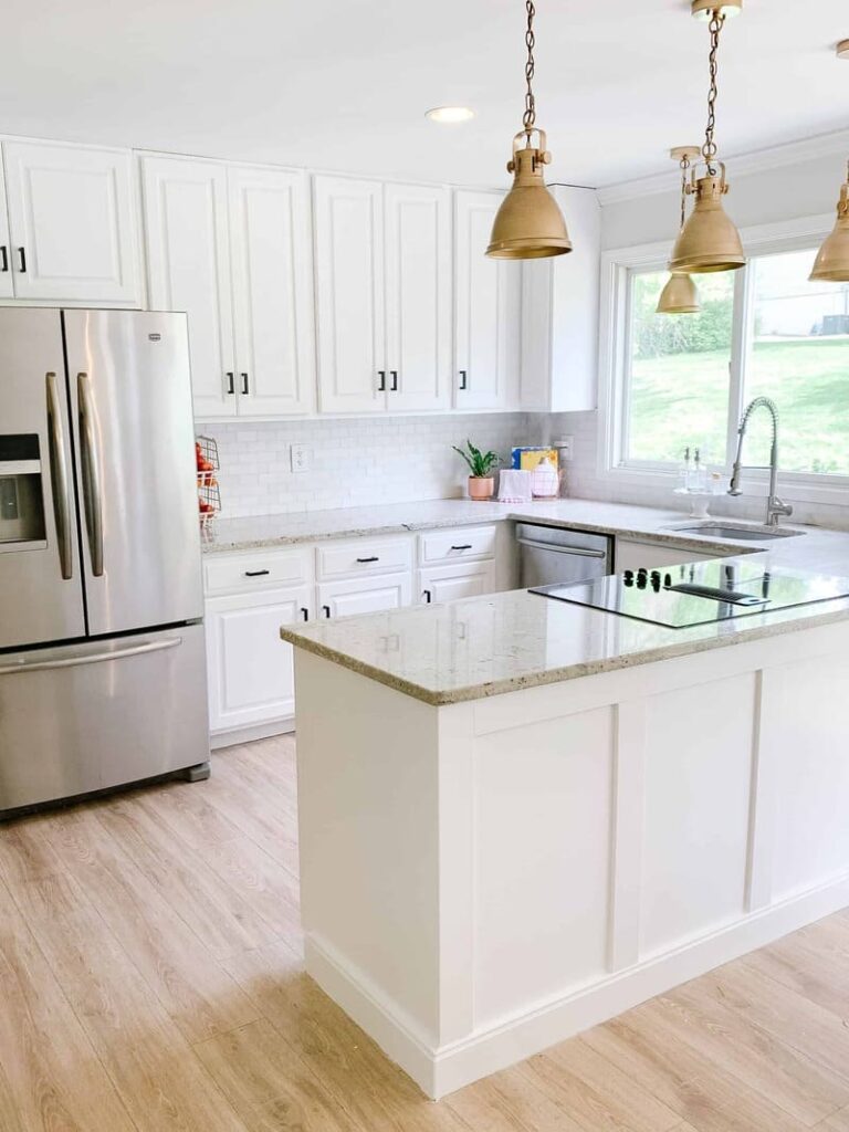 Sleek kitchen featuring painted kitchen cabinets in a soft matte white finish