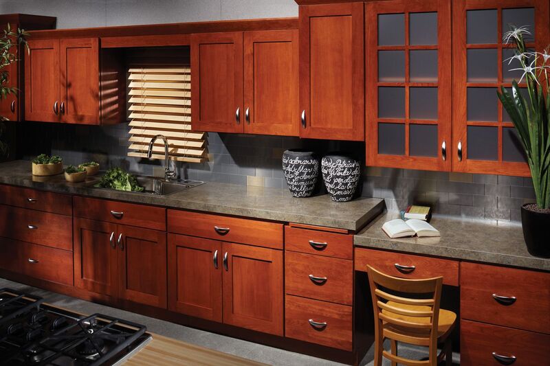 Rustic kitchen with chestnut brown cabinets, sage green walls, and wooden countertops for an earthy look