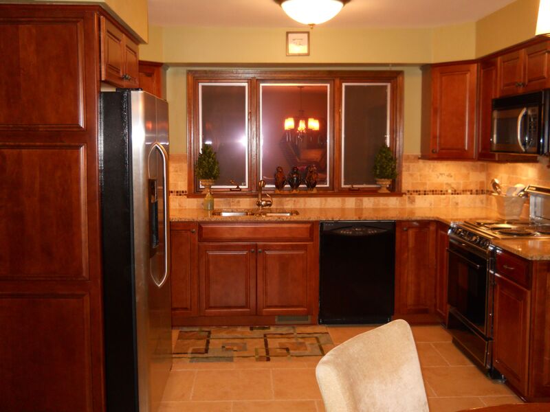 Chestnut brown painted kitchen cabinets in a warm, transitional home