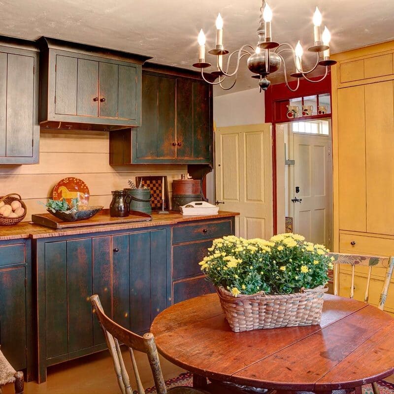 Cozy kitchen with mid-tone brown painted cabinets and warm lighting