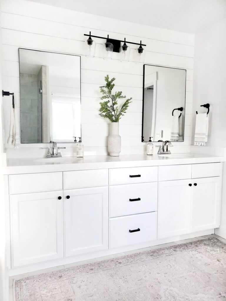 A modern bathroom vanity featuring chrome knobs and moisture-resistant pulls for a balanced and stylish appearance