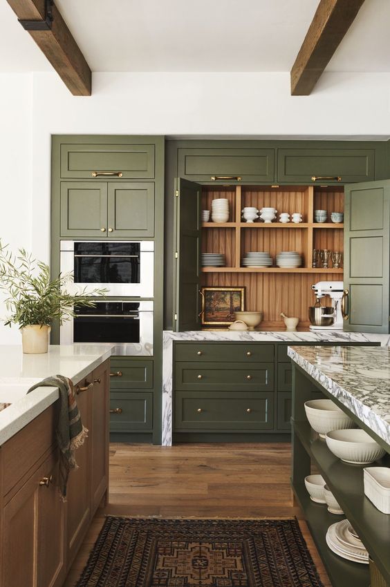 A rustic kitchen featuring olive green painted cabinet