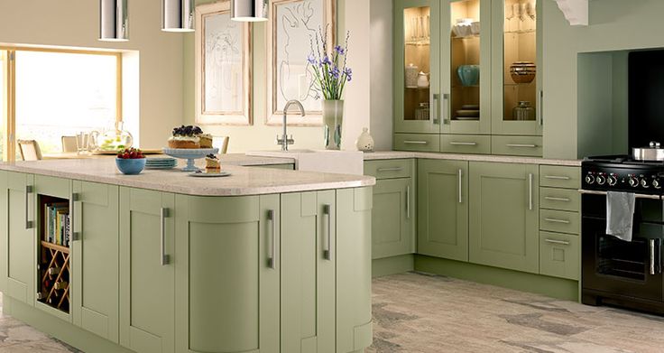 A transitional kitchen featuring pistachio green cabinets with neutral quartz countertops