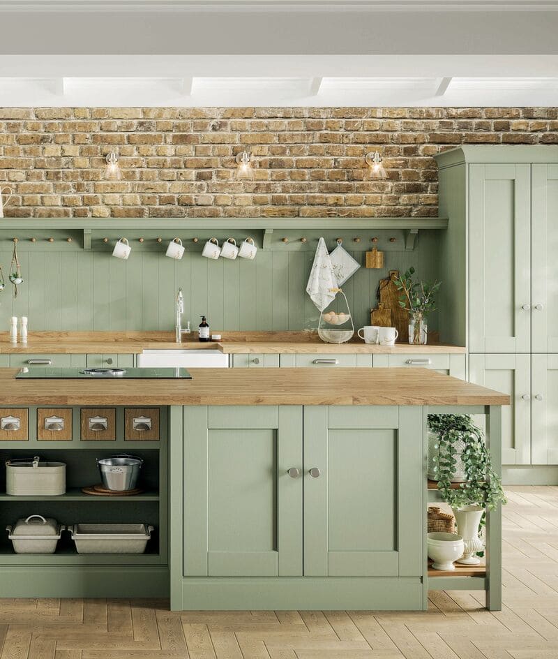 A farmhouse kitchen with sage green painted cabinets, exuding charm and simplicity