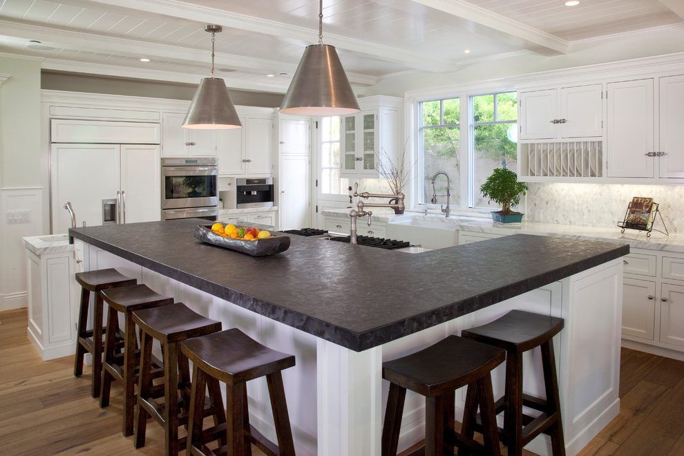 Custom kitchen island with L-shaped design for integrated seating and storage in a modern home