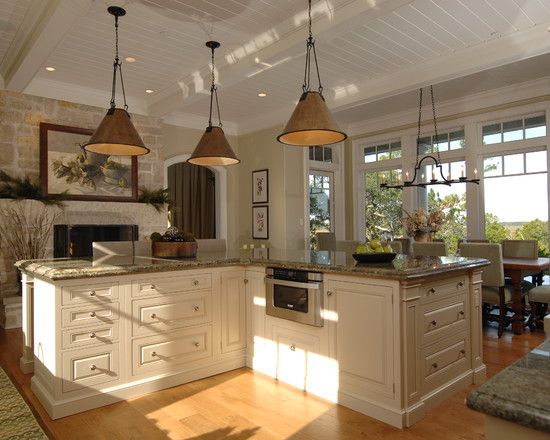 A well-lit L shaped kitchen with island for a sophisticated look