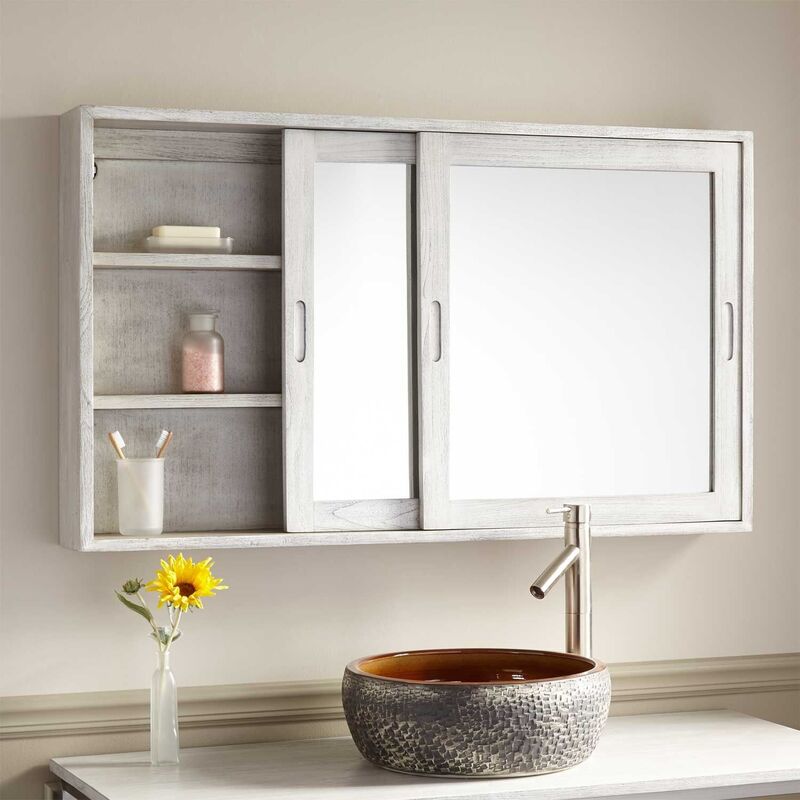 A contemporary bathroom featuring a long medicine cabinet with a sleek mirror and ample storage space