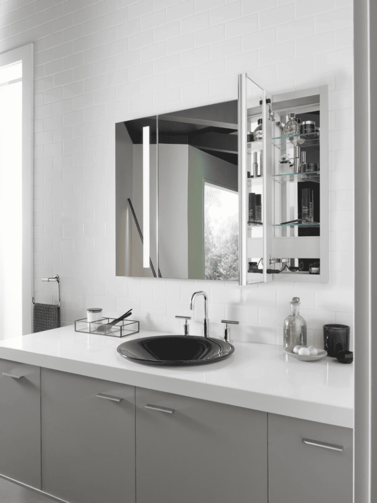 A stylish bathroom featuring a long medicine cabinet with adjustable shelves and integrated lighting