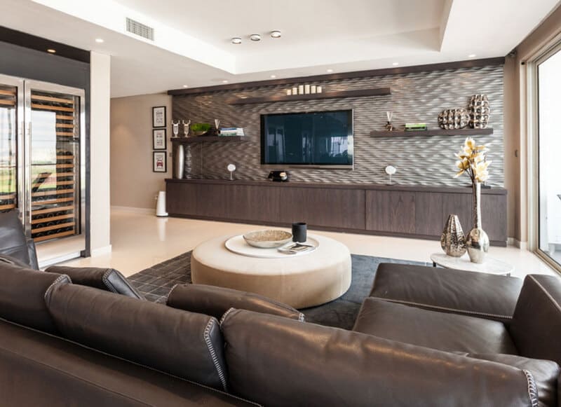 A contemporary media cabinet showcasing perfect width alignment with a wall-mounted TV in a modern family room