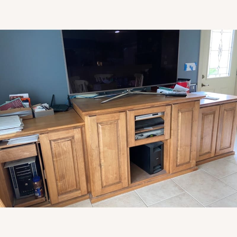 A deep custom media cabinet designed for high-capacity storage and advanced cable management in a home office