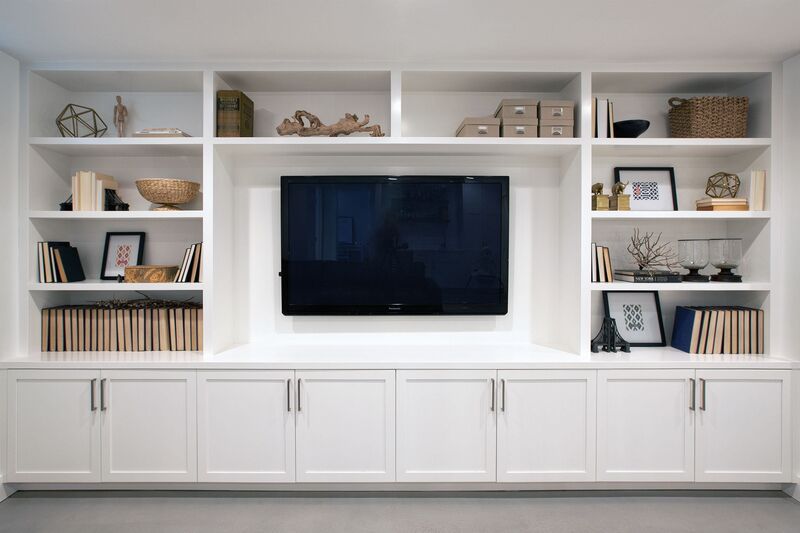 A sleek, wide media cabinet with ample shelving, perfectly placed in a large, open-plan living room for balance and functionality