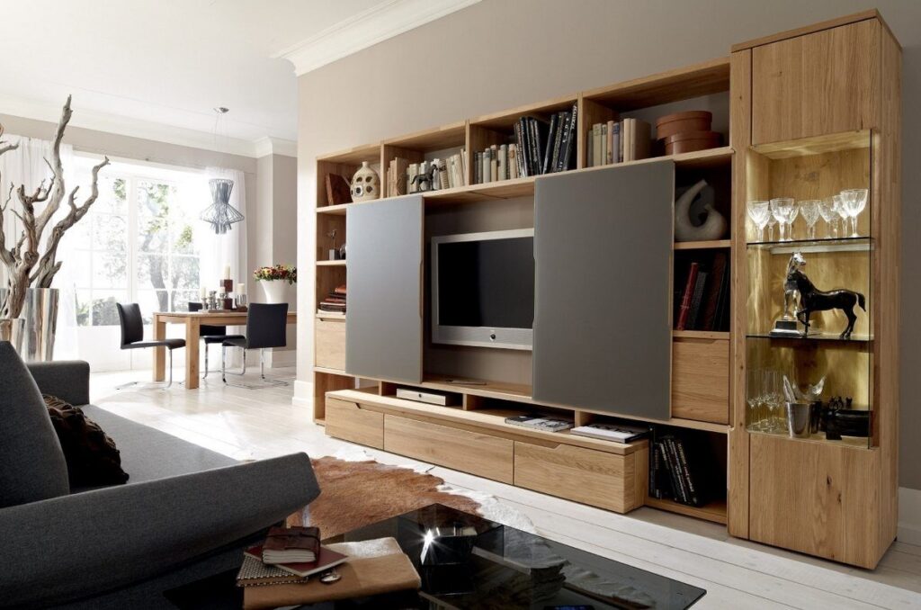 A media wall cabinet with hidden compartments and adjustable shelves, perfect for organizing electronics in a stylish setting