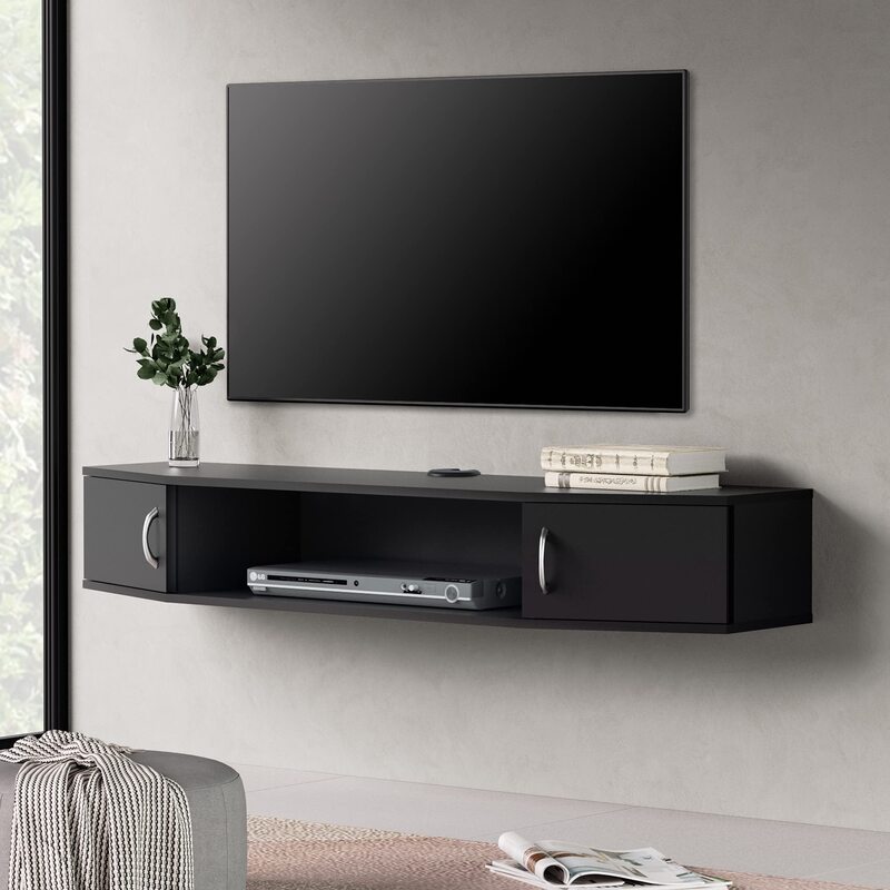 A sleek floating media wall cabinet in black, enhancing a minimalist living room with integrated storage