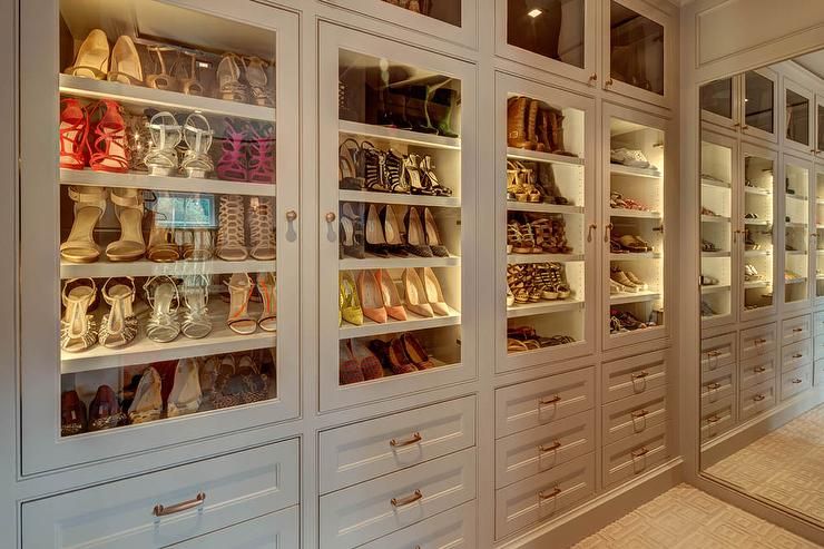 A wide custom shoe cabinet designed with multiple tiers and compartments, ideal for a spacious walk-in closet