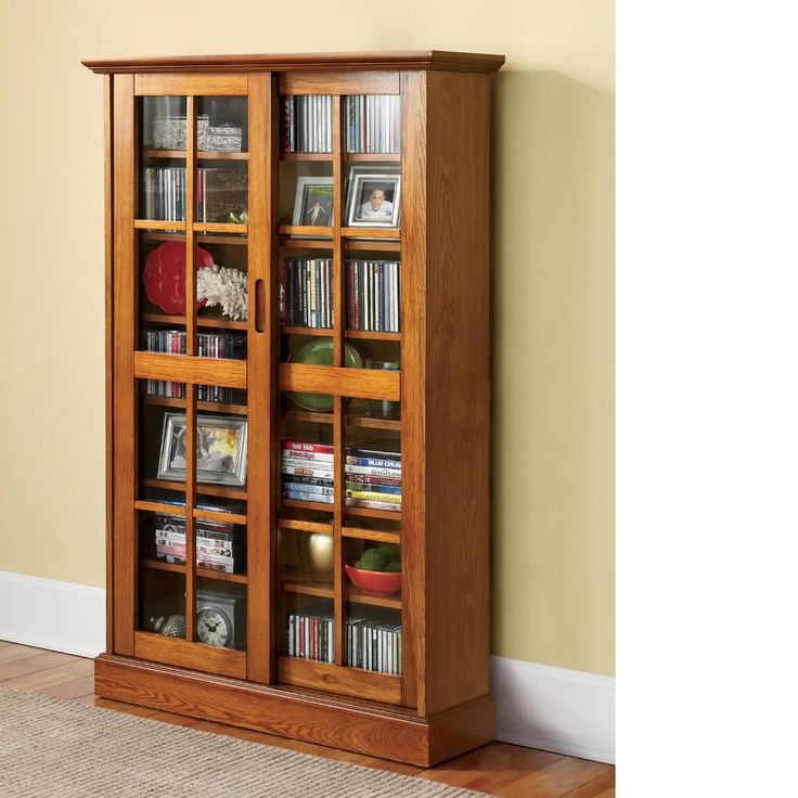 A sliding door media cabinet with frosted glass doors, integrated versatile shelving, complementing a modern minimalist living room