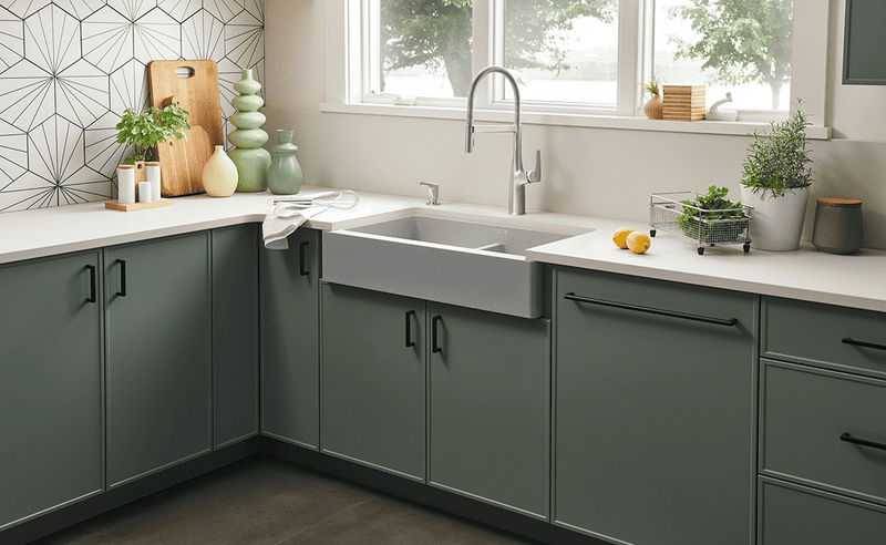 A modern kitchen featuring cost-effective grey Slim Shaker RTA cabinets, paired with white countertops and black hardware