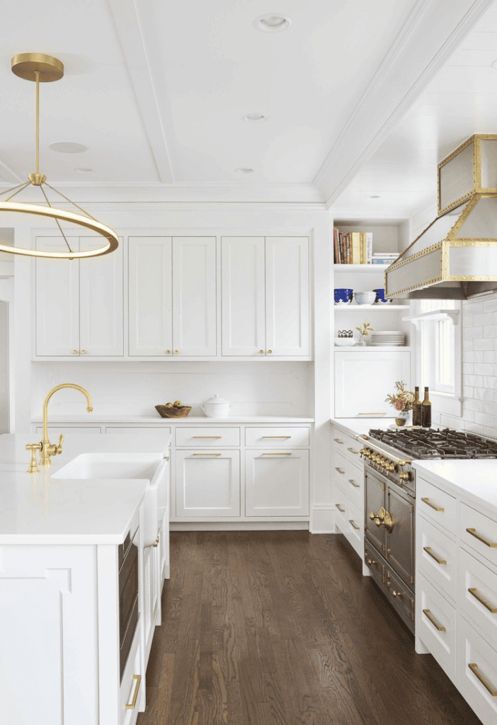 A contemporary kitchen featuring stainless steel cabinet hardware paired with white, sleek cabinetry for a modern touch