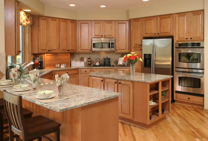 A modern U shaped kitchen cabinet design featuring custom finishes for enhanced functionality and style