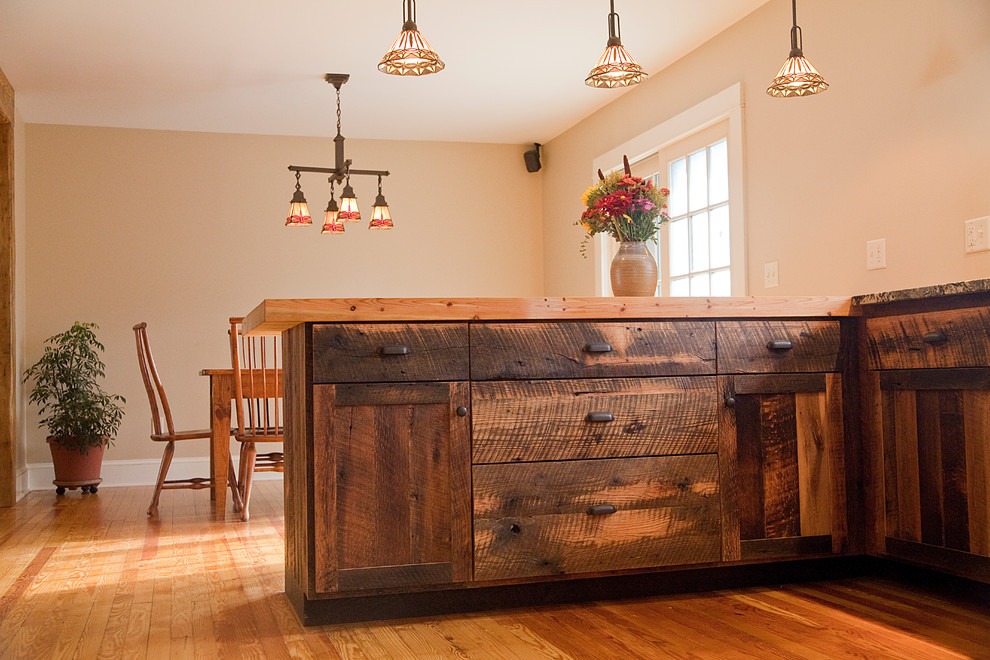 Sustainable wood finish kitchen cabinets made from reclaimed oak, showcasing visible grain and natural imperfections in a rustic design