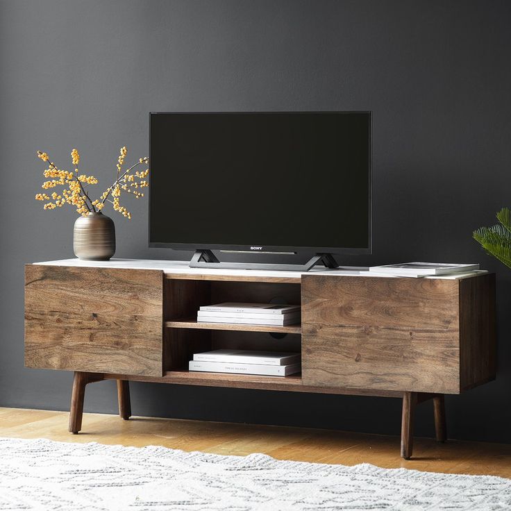 A traditional dark wood media cabinet with intricate carvings, perfect for a luxurious living room