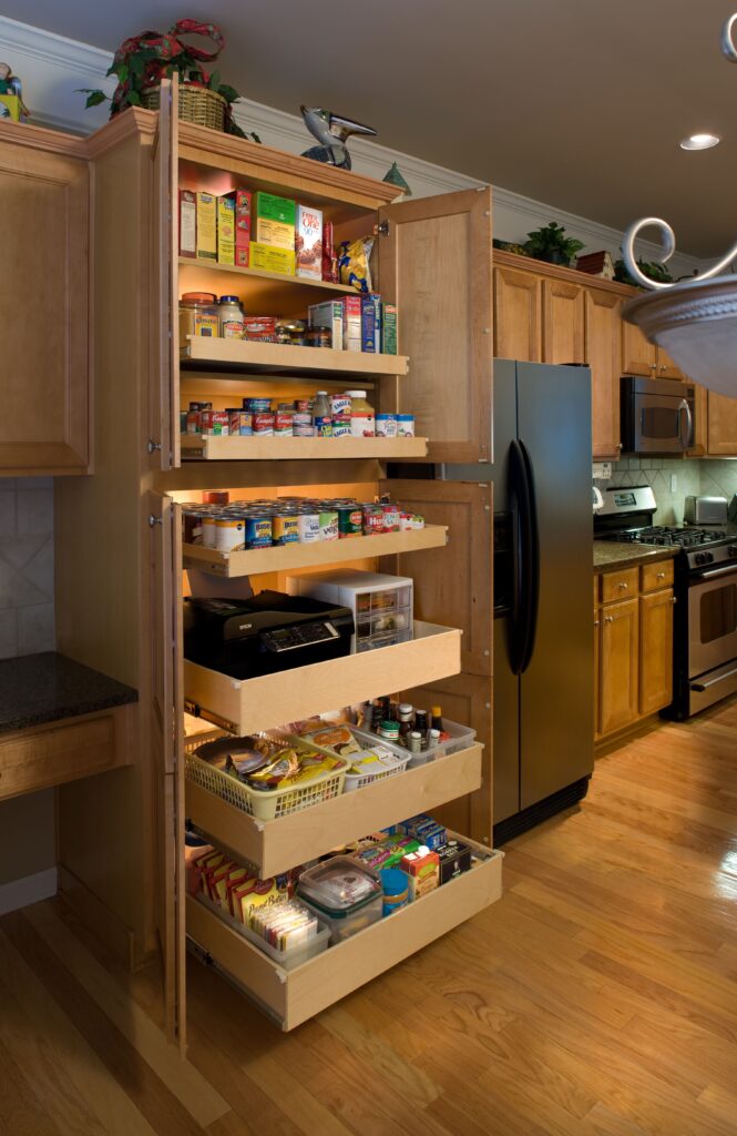 Slim pull-out pantry cabinet with vertical shelves, designed to fit compact kitchens and maximize narrow storage spaces