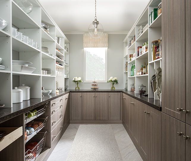 Spacious walk-in pantry cabinet featuring custom shelving, pull-out baskets, and compartments for bulk storage, ideal for large kitchens