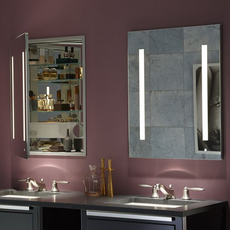 A frameless medicine cabinet with LED lighting, adjustable shelves in a modern bathroom