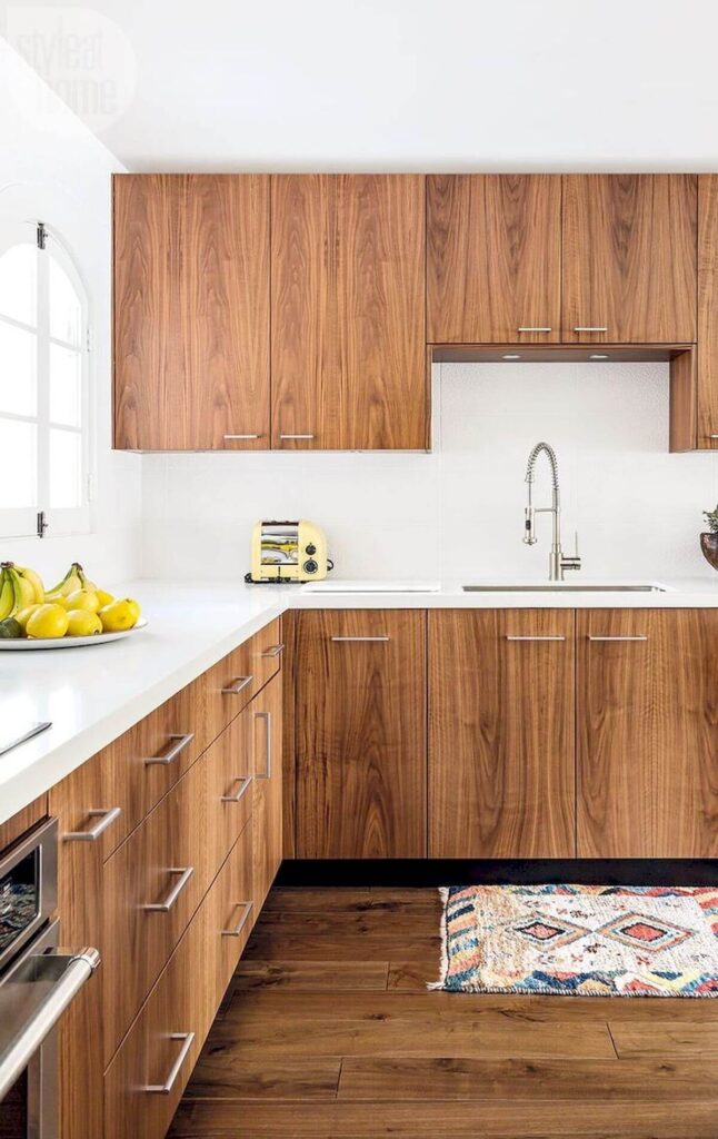 A modern kitchen featuring kitchen cabinet veneers with a natural wood grain finish, highlighting contemporary Scandinavian design