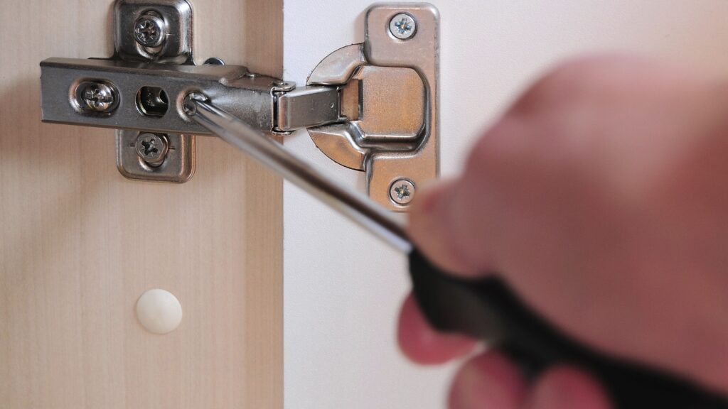 Quality control technician measuring hinge damping force to ensure consistent soft close cabinets cost and performance